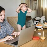 mom working from home with kid distracting her