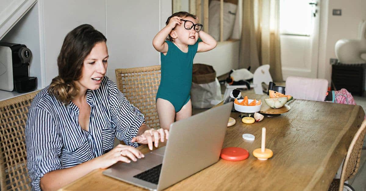 mom working from home with kid distracting her